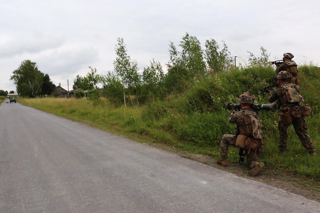 U.S. Marines with Charlie Company, 1st Battatlion 8th Marine Regiment, Special Purpose Marine Air-Ground Task Force-Crisis Response-Africa prepare to engage a vehicle with an M136 AT4 Anti-Tank Rocket training tube during a combined arms attack aboard Camp Sissonne, France, June 21, 2016. During CENZUB training SPMAGTF-CR-AF Marines had the opportunity to work in cooperation with company of French Army soldiers, integrating their skills and resources including weaponry and military vehicles to form an effective battle plan, similar to what they may face in the event of a future crisis. (U.S. Marine Corps photo by Sgt. Kassie McDole/Released.) 