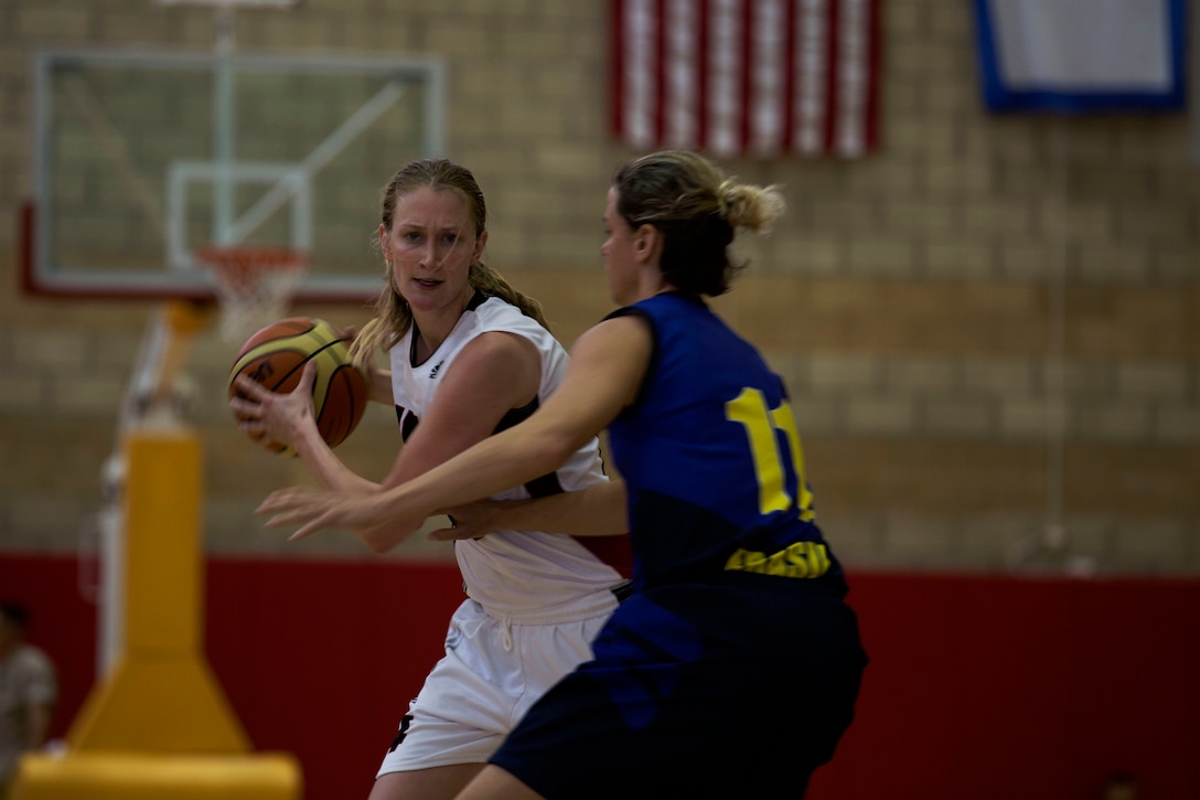 Canadian Army Capt. Abby Edmison of the Canadian Military Women’s Basketball Team works her way around a defender during the Canada vs. Brazil game at the Conseil International Du Sport Militaire (CISM) World Military Women’s Basketball Championship July 27 at Camp Pendleton, California. The base is hosting the CISM World Military Women’s Basketball Championship July 25 through July 29 to promote peace activities and solidarity among military athletes through sports. (U.S. Marine Corps photo by Sgt. Abbey Perria)