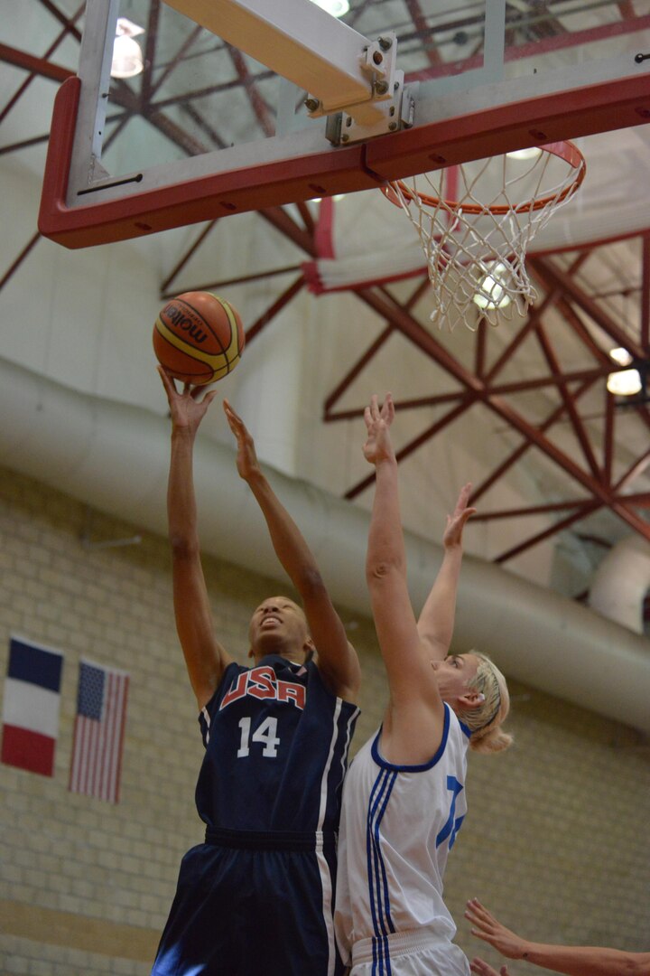 2nd Lt. Danielle Salley from Fort Bragg, N.C., lays it up over France's Johanna Cortinovis during USA's 85-53 win over France in the 2nd day of the CISM Women's Basketball Championship at Camp Pendleton, Calif., July 26, 2016,