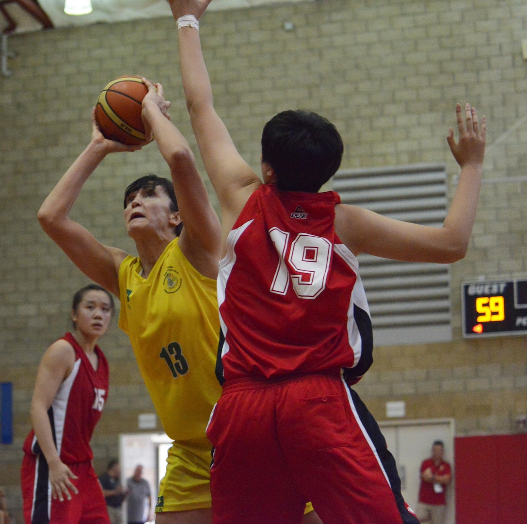 Brazil's Soeli Garvao Zakrzeski shoots past Chinese defender Tianyang Zang during day two of the CISM Women's Basketball Championship at Camp Pendleton, Calif., July 26, 2016. Brazil beat China 68-66.