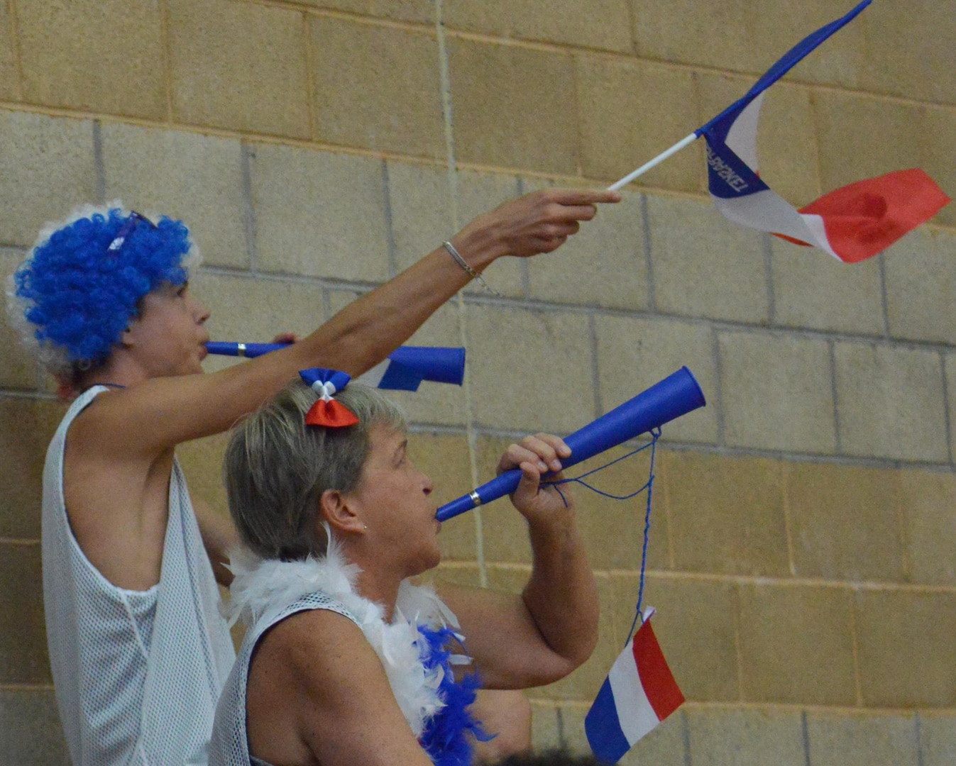 French fans blow their horns and wave their nation's flag after their team scores during day two of the CISM Women's Basketball Championship at Camp Pendleton, Calif., July 26, 2016. Despite their support, France lost to Team USA, 85-53.