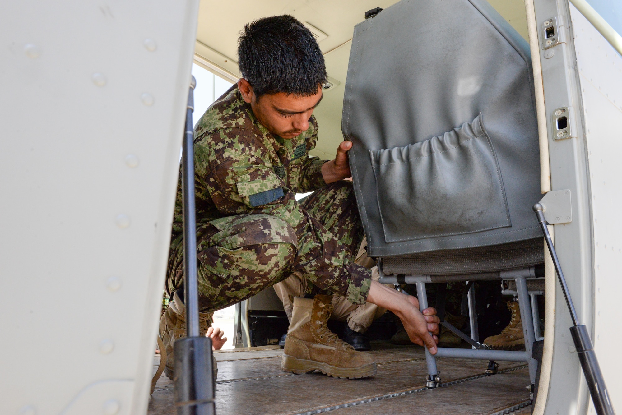 A member of the Afghan air force medical squadron practices removing a seat from a C-208 for medical transport at Hamid Karzai International Airport, Kabul, Afghanistan, July 27, 2016. Train, Advise, Assist Command-Air (TAC-Air) members work closely with AAF members to regularly conduct training so they can remain proficient in their respective skill sets. (U.S. Air Force photos by Tech. Sgt. Christopher Holmes)
