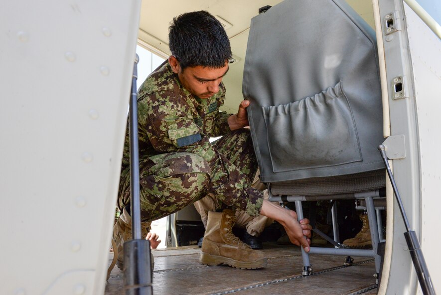 A member of the Afghan air force medical squadron practices removing a seat from a C-208 for medical transport at Hamid Karzai International Airport, Kabul, Afghanistan, July 27, 2016. Train, Advise, Assist Command-Air (TAC-Air) members work closely with AAF members to regularly conduct training so they can remain proficient in their respective skill sets. (U.S. Air Force photos by Tech. Sgt. Christopher Holmes)
