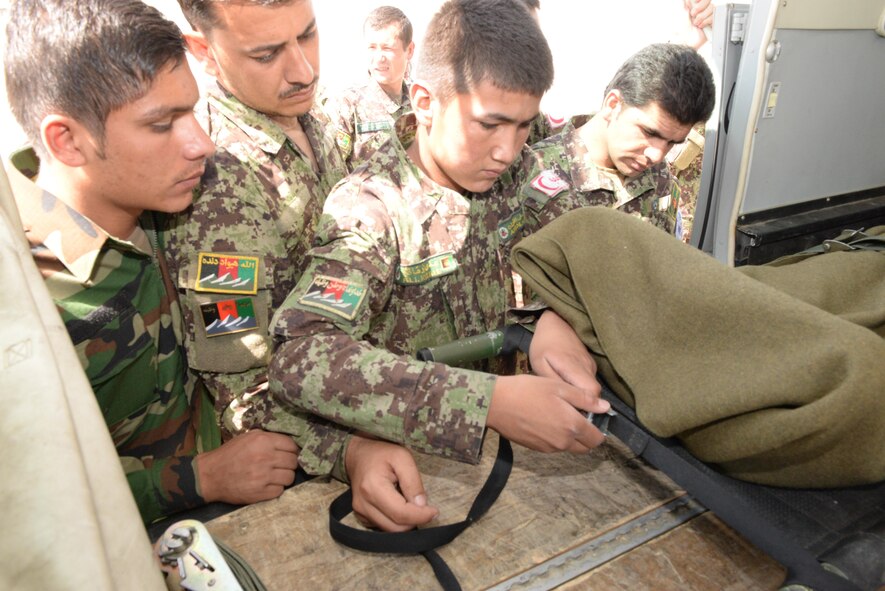 Afghan air force medical personnel practice securing a litter to the floor of a C-208 for medical transport at Hamid Karzai International Airport, Kabul, Afghanistan, July 27, 2016. Train, Advise, Assist Command-Air (TAAC-Air) personnel work closely with their AAF counterparts to regularly conduct training so that they can remain proficient in their respective skill sets. (U.S. Air Force photos by Tech. Sgt. Christopher Holmes)
