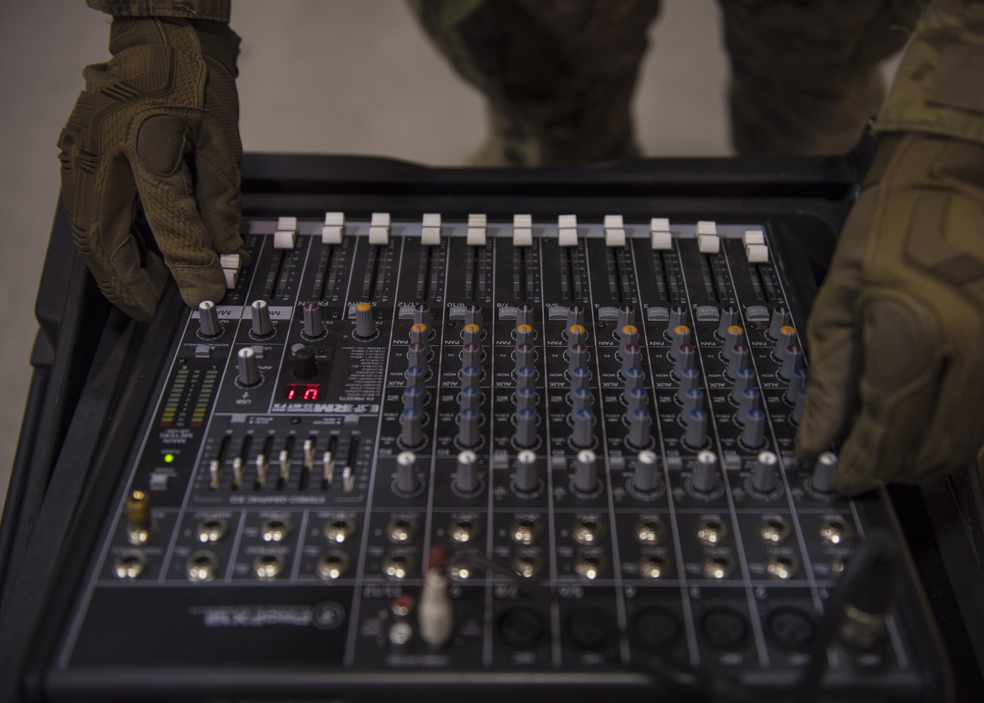 Senior Airman Ryan Custodio, 455th Expeditionary Communications Squadron, radio frequency transmission system technician, adjust the volume levels on a mixer, Bagram Airfield, Afghanistan, July 27, 2016. The RF transmissions section provides public address system support for official functions such as change of command ceremonies and distinguish visitors. (U.S. Air Force photo by Senior Airman Justyn M. Freeman)