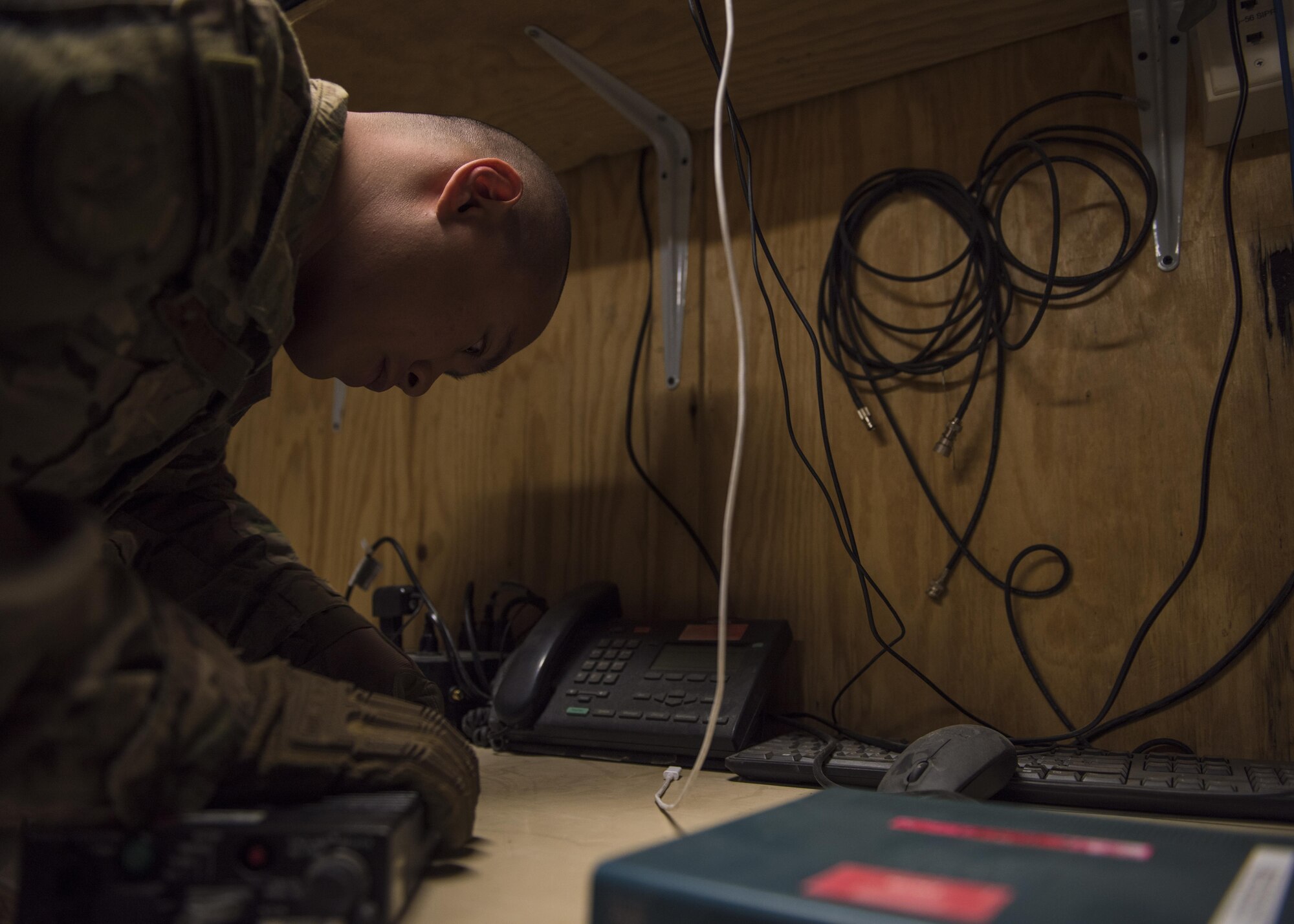 Senior Airman Ryan Custodio, 455th Expeditionary Communications Squadron, radio frequency transmission system technician, assembles a communication fly away kit, Bagram Airfield, Afghanistan, July 27, 2016. The communication flyaway kit provides backup service for all communications on the base broadband global area network. (U.S. Air Force photo by Senior Airman Justyn M. Freeman)