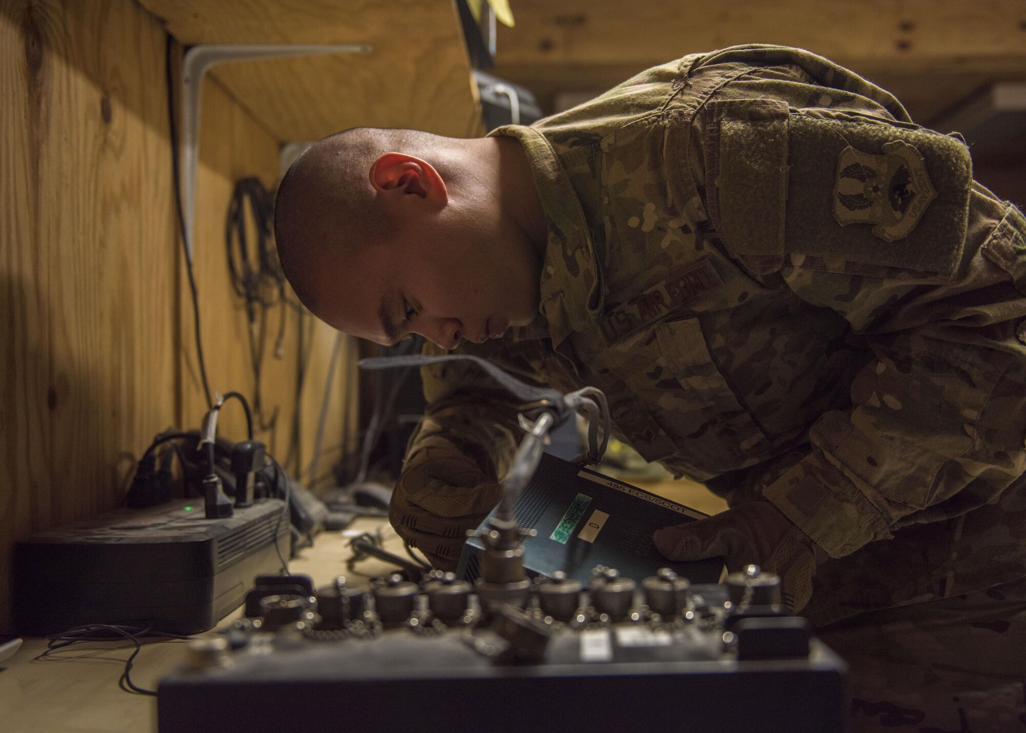 Senior Airman Ryan Custodio, 455th Expeditionary Communications Squadron, radio frequency transmission system technician, assembles a communication fly away kit, Bagram Airfield, Afghanistan, July 27, 2016. RF transmission technicians deploy, sustain, troubleshoot and repair a vast variety of communications devices to include antenna systems, tuners and transmission lines. (U.S. Air Force photo by Senior Airman Justyn M. Freeman)