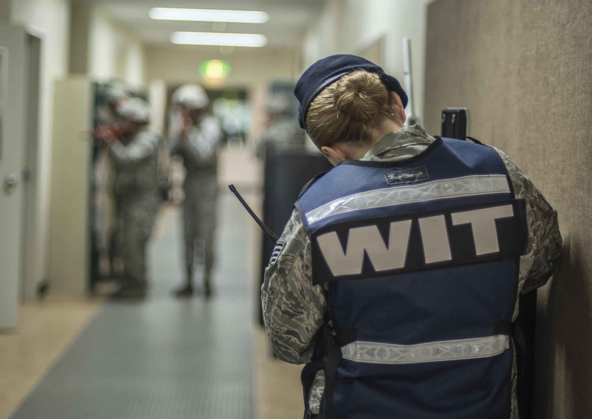 U.S. Air Force Staff Sgt. Kathleen Sullivan, a standardization and evaluation member with the 35th Security Forces Squadron, observes security forces members as they clear rooms during the Beverly Sunrise 16-05 active shooter exercise held July 29, 2016, at Misawa Air Base, Japan. During the exercise, Sullivan evaluated security forces members' capabilities in responding to a crisis situation. (U.S. Air Force photo by Senior Airman Brittany A. Chase)