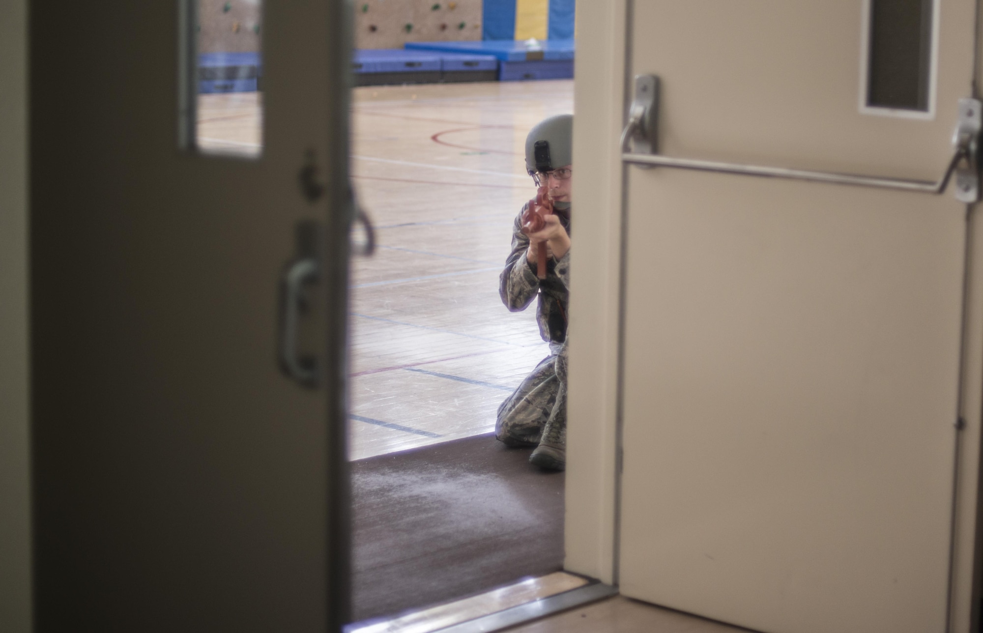 U.S. Air Force Senior Airman Zachary Justice, an alarm monitor and police two patrolman with the 35th Security Forces Squadron, guards the entryway of a gymnasium during the Beverly Sunrise 16-05 active shooter exercise held July 29, 2016, at Misawa Air Base, Japan. Justice was one of six team members who cleared the building where the active shooter exercise was held. (U.S. Air Force photo by Senior Airman Brittany A. Chase)