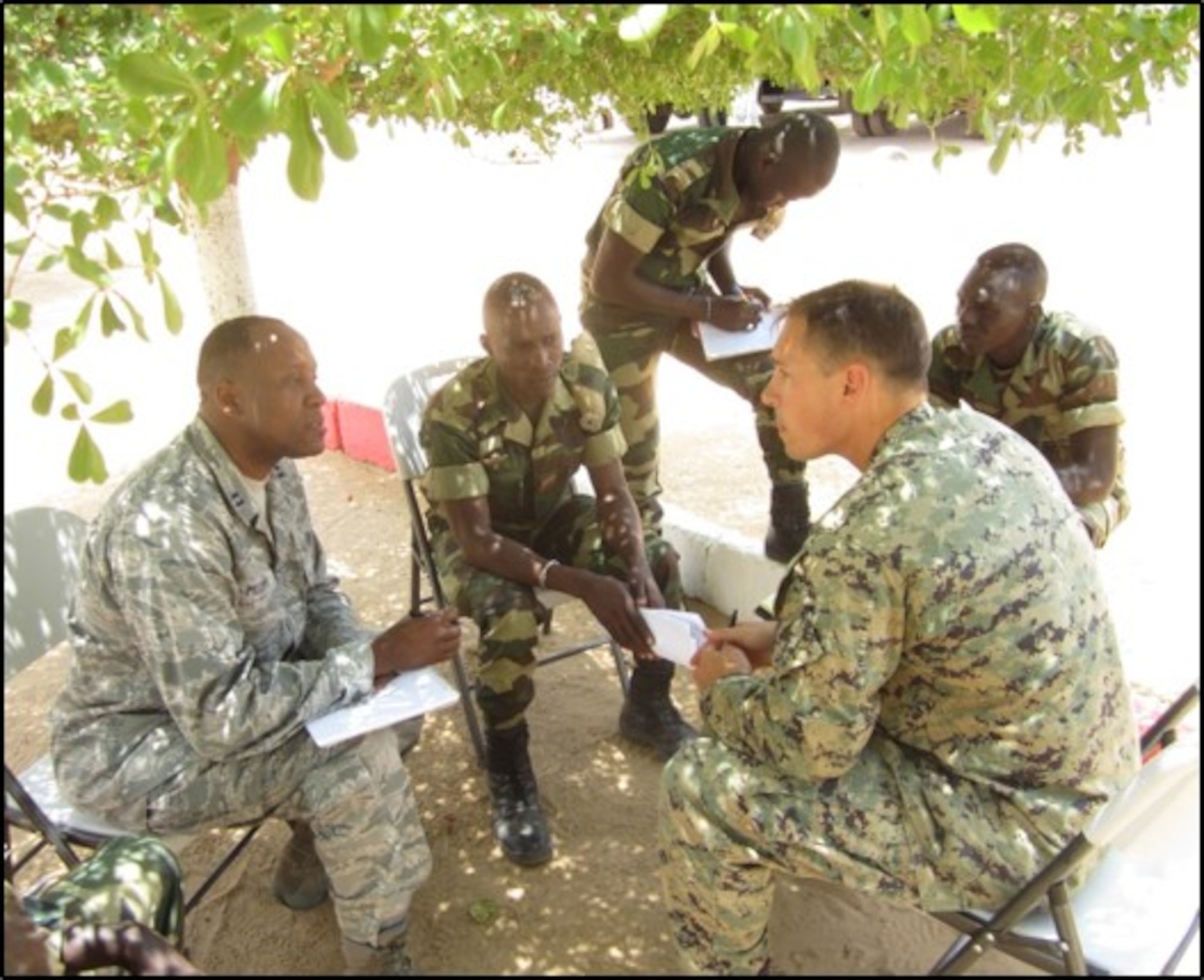 Air Force Capt. Patrick Mudimbi (left) translates for Marine Corps Chief Warrant Officer Jonathan Ross during a training scenario in Senegal for Senegalese soldiers to counter terrorist activities. 