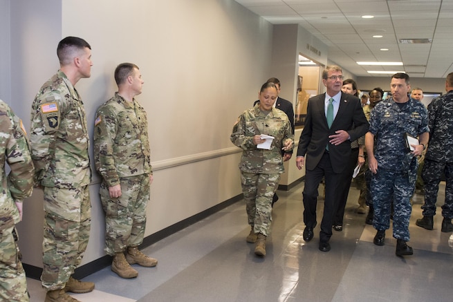 Defense Secretary Ash Carter meets with workers during a visit to the Chicago Military Entrance Processing Station 