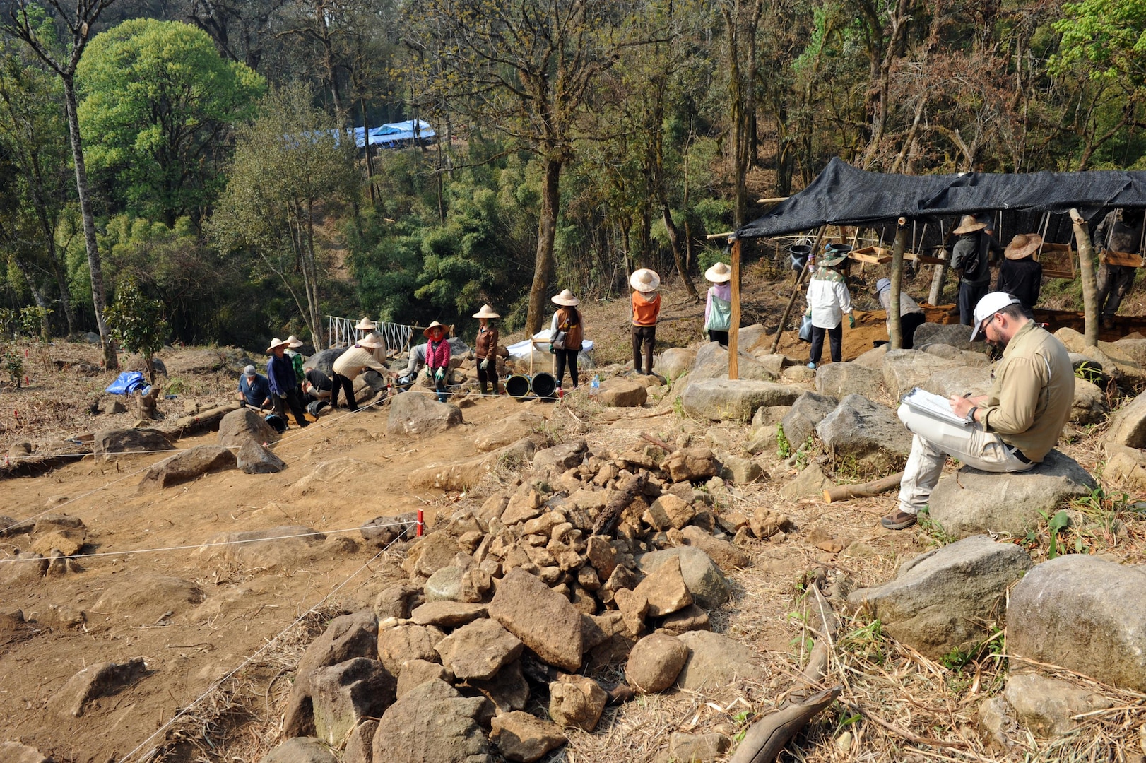 Joe Griffin, a senior archaeologist with the Army Corps of Engineers and recovery leader augmentee for the Defense POW/MIA Accounting Agency (DPAA), takes notes on all activities on site during excavation in the Xiangkhoang Province, Lao People’s Democratic Republic, March 10, 2016. Members of DPAA deployed to the area in hopes of recovering the remains of a pilot unaccounted for during the Vietnam War. DPAA’s mission is to provide the fullest possible accounting for our missing personnel to their families and the nation. 