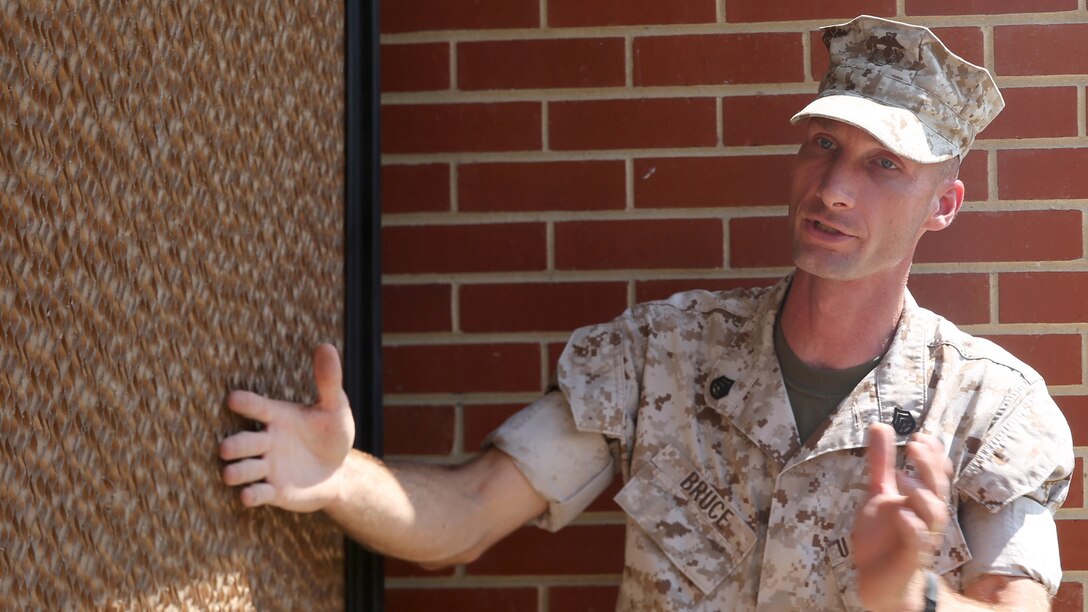 Staff Sgt. Mark Bruce, engineer chief with Chemical Biological Incident Response Force explains how a portable cooler uses large coils soaked in water and a fan to provide cooling at the local chow hall aboard Naval Support Facility Indian Head, Maryland, July 22, 2016. The event provided the Marines with the engineer platoon hands-on training further sharpening their skills for expeditionary operations. 