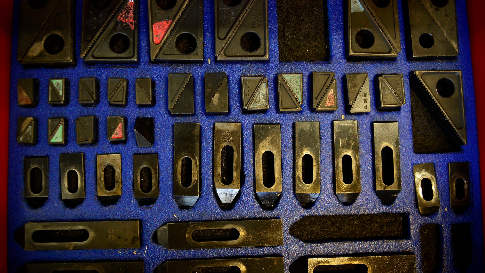 Computer numeric control machining clamps sit inside a toolbox drawer, July 27, 2016, at Aviano Air Base, Italy. Clamps are used in CNC machines to hold metal in place before it’s cut. (U.S. Air Force photo by Airman 1st Class Cary Smith/Released) 