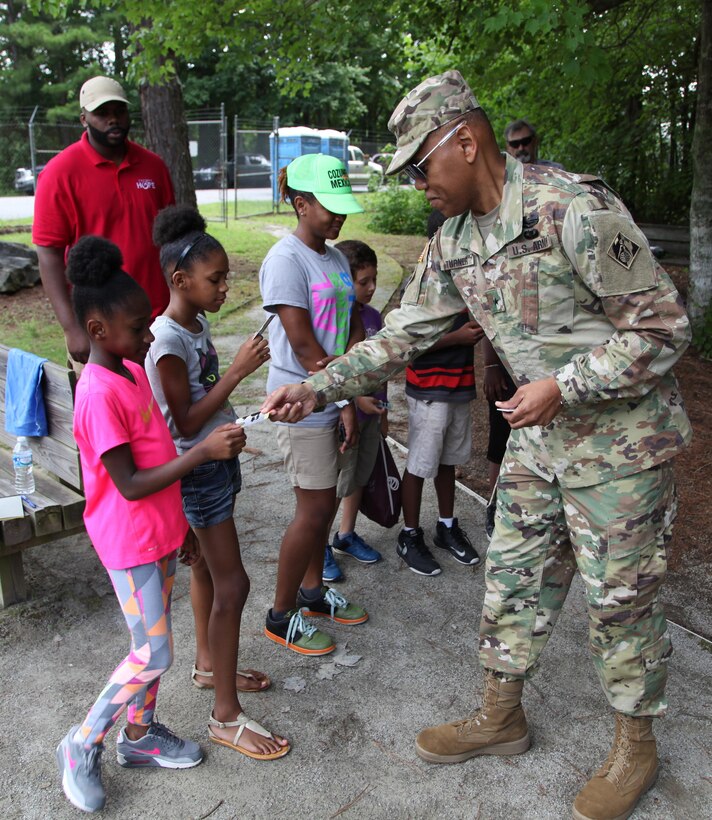 South Atlantic Division Commander Brigadier General C. David Turner provides youth a 2017 Every Kid in a Park annual pass at Lake Sidney Lanier catfish pond July 27. Turner visited youth as part of an Every Kid in a Park (EKIP) initiative, a White House effort that grants fourth-grade students and their families free admission to U.S. Army Corps of Engineers recreational areas and more than 2,000 federally managed sites nationwide. 