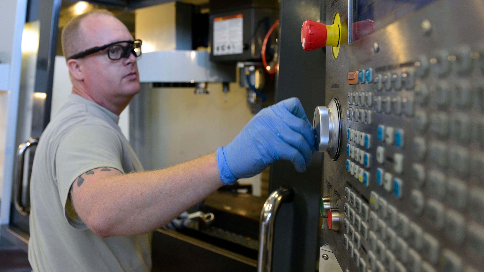 Master Sgt. Kyle Eickhoff, 31st Maintenance Squadron Metals Technology section chief, programs a computer numeric control machine to cut a metal part, July 27, 2016, at Aviano Air Base, Italy. Eickhoff used the CNC machine to cut parts for a radar mount. (U.S. Air Force photo by Airman 1st Class Cary Smith/Released) 