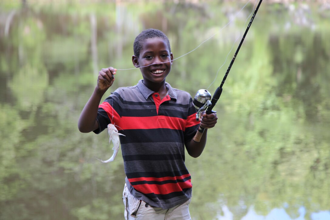 A youth visitor displays a fish caught at Lake Sidney Lanier in Buford, Georgia July 27. 