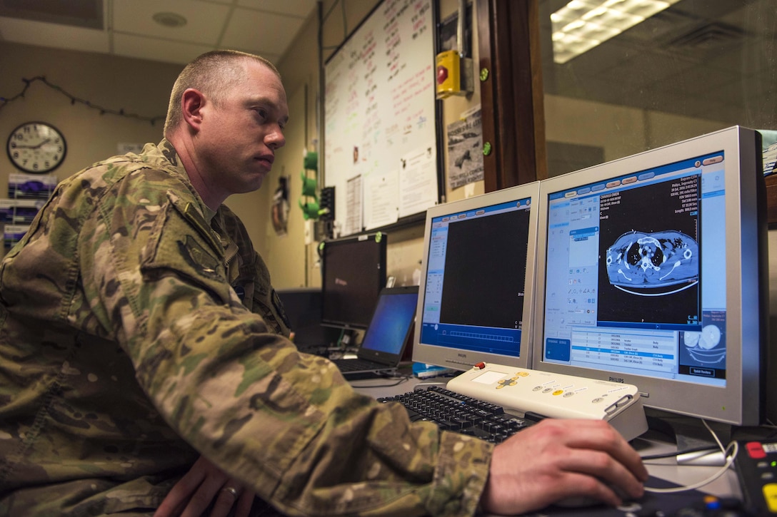 Air Force Staff Sgt. Christopher Moore reads the results of a CT scan at Bagram Airfield, Afghanistan, July 20, 2016. Moore is a diagnostic imaging technician assigned to the 455th Expeditionary Medical Group. Air Force photo by Senior Airman Justyn M. Freeman 