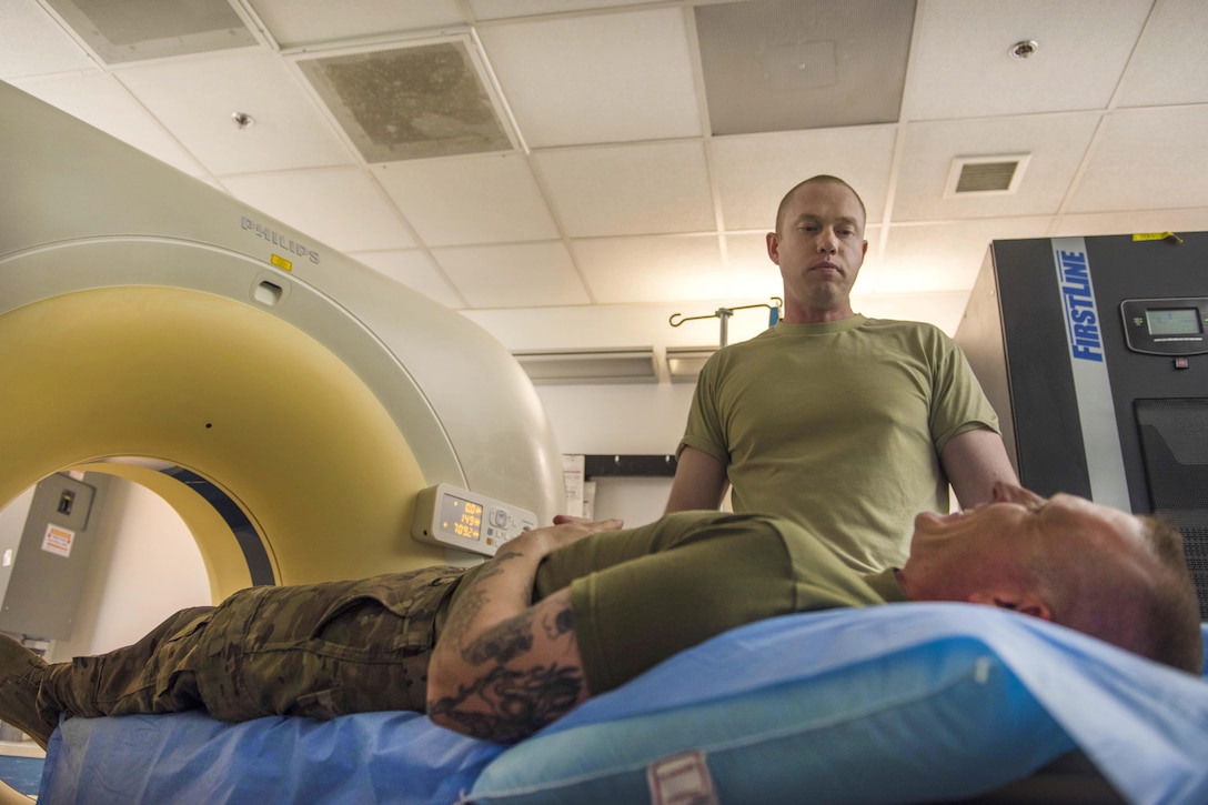 Air Force Staff Sgt. Christopher Moore prepares a patient for an abdominal and pelvic CT scan at Bagram Airfield, Afghanistan, July 20, 2016. Air Force photo by Senior Airman Justyn M. Freeman