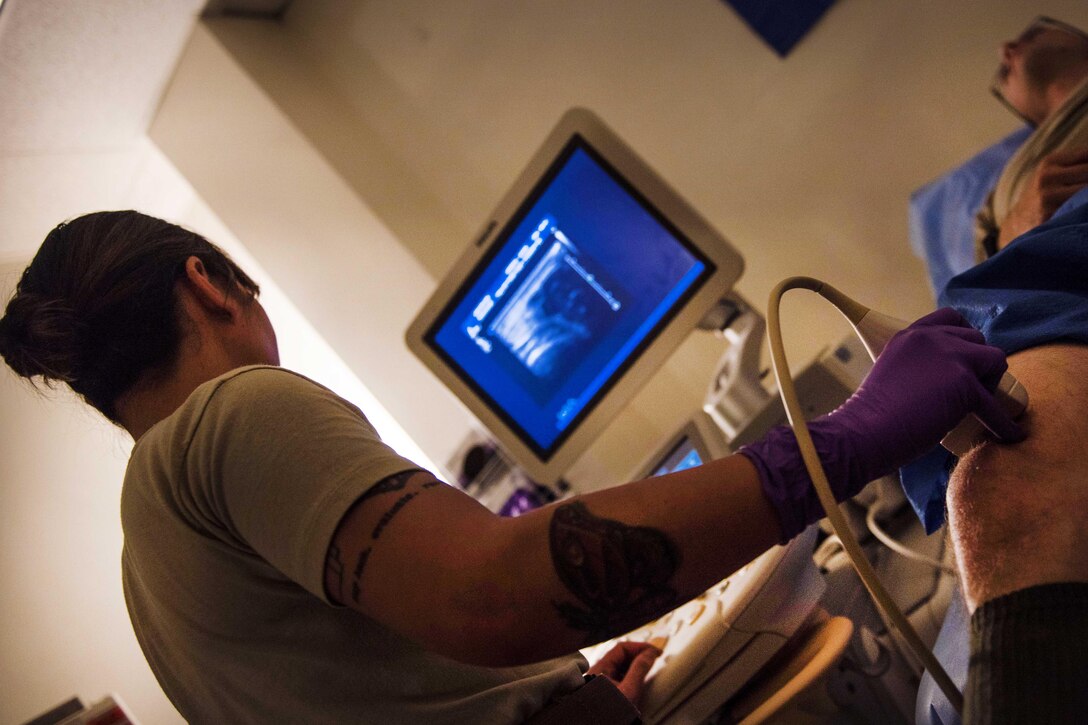 Air Force Staff Sgt. Christine Blanco, left, performs an ultrasound on a patient at Bagram Airfield, Afghanistan, July 20, 2016. Blanco is an ultrasound technologist assigned to the 455th Expeditionary Medical Group. Air Force photo by Senior Airman Justyn M. Freeman