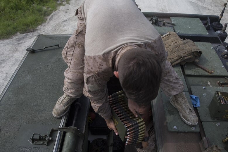 A Marine with Alpha Company, 2nd Assault Amphibian Battalion, prepares .50 caliber rounds prior to a live-fire gunnery range at Camp Lejeune, N.C., July 27, 2016. Individual Marines were required to engage ivan and hard targets at various ranges while determining whether to use the M-2 .50 caliber machine gun or the MK-19 40mm grenade launcher.