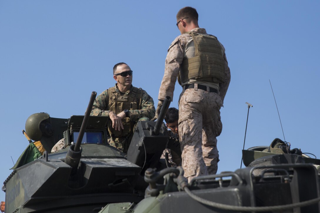 Maj. Gen. John K. Love, 2nd Marine Division commanding general, speaks with Marines before conducting a live-fire gunnery range at Camp Lejeune, N.C., July 27, 2016. Marines with 2nd Assault Amphibian Battalion spent the day refining their marksmanship skill as individuals and their ability to work as an AAV crew.