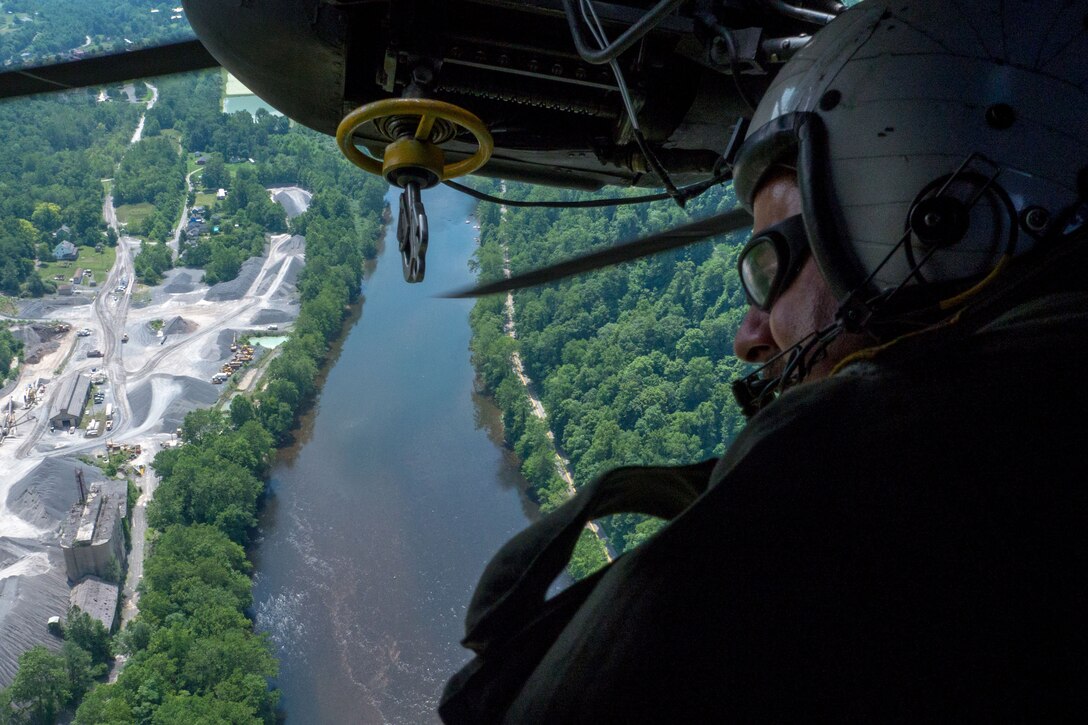 Navy Senior Chief Petty Officer Paul Morreira surveys a landing zone from the window of an MH-53E Sea Dragon during training to familiarize the crew with mountainous terrain near Camp Dawson, W.Va., July 22, 2016. The squadron participated in the two-day training evolution as part of an upcoming exercise with the Army. Morreira is a crewman assigned to Helicopter Mine Countermeasures Squadron 15. Navy photo by Petty Officer 1st Class Barry A. Riley