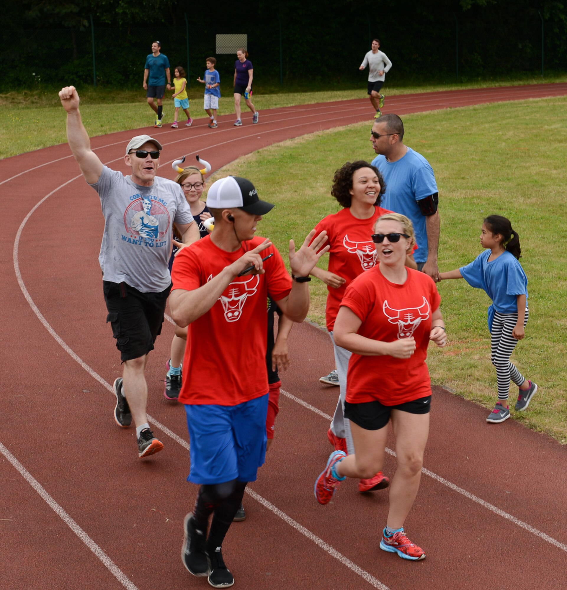 Runners celebrate finishing their last lap during the Viking Challenge July 23, 2016, at Pulaski Barracks, Germany. After the marathon ended, awards and appreciation were given out from the Kaiserslautern Military Community Council. (U.S. Air Force photo/Airman 1st Class Savannah L. Waters)