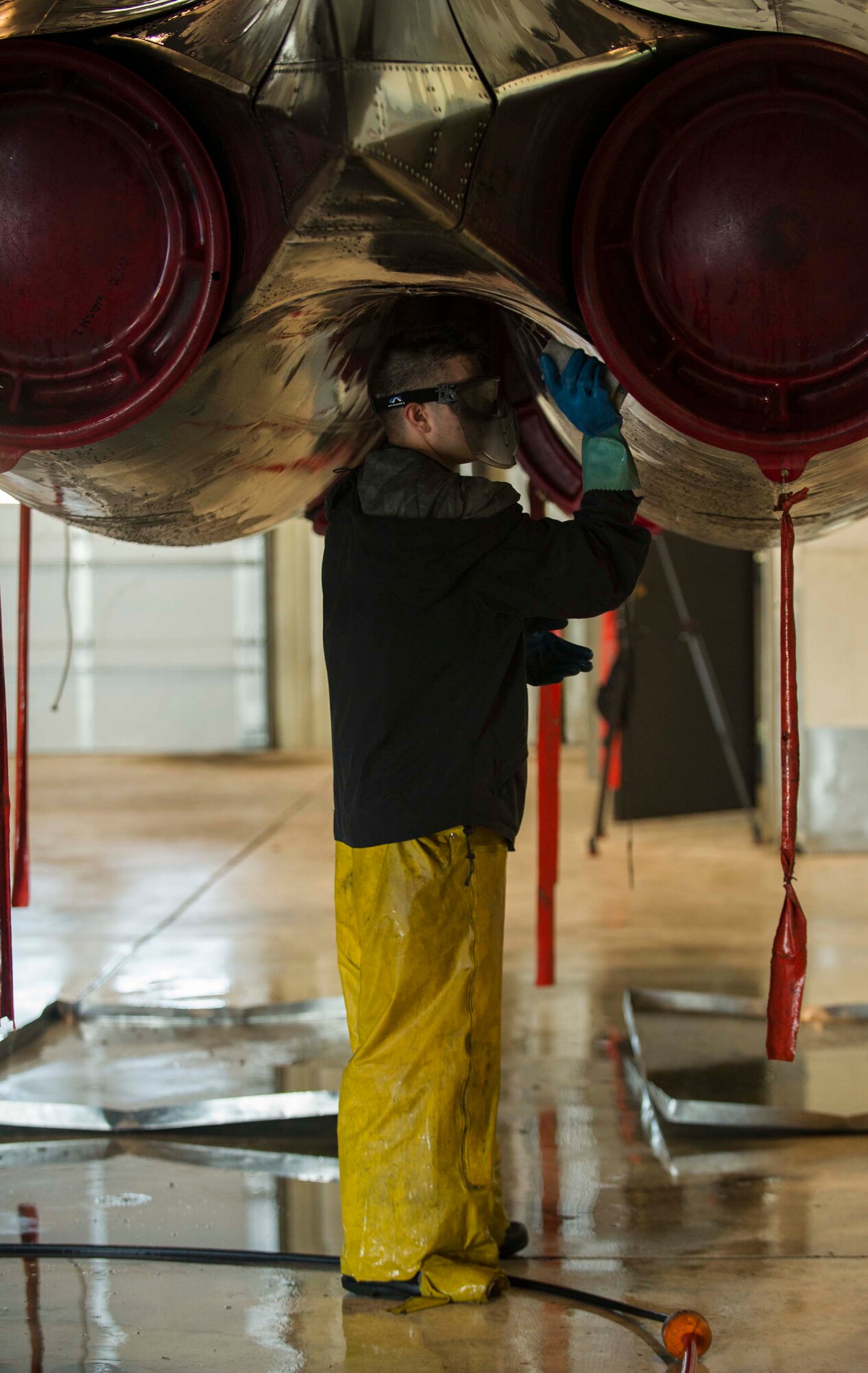 An Airman from the 5th Aircraft Maintenance Squadron washes a B-52H Stratofortress at Minot Air Force Base, N.D., July 25, 2016. The thorough wash usually takes two days to complete. (U.S. Air Force photo/Senior Airman Apryl Hall)