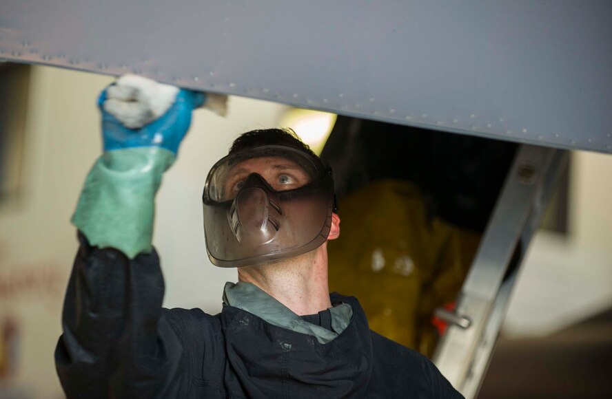 An Airman from the 5th Aircraft Maintenance Squadron washes a B-52H Stratofortress at Minot Air Force Base, N.D., July 25, 2016. Each aircraft is required to be washed every 120 days or after 450 flying hours. (U.S. Air Force photo/Senior Airman Apryl Hall)