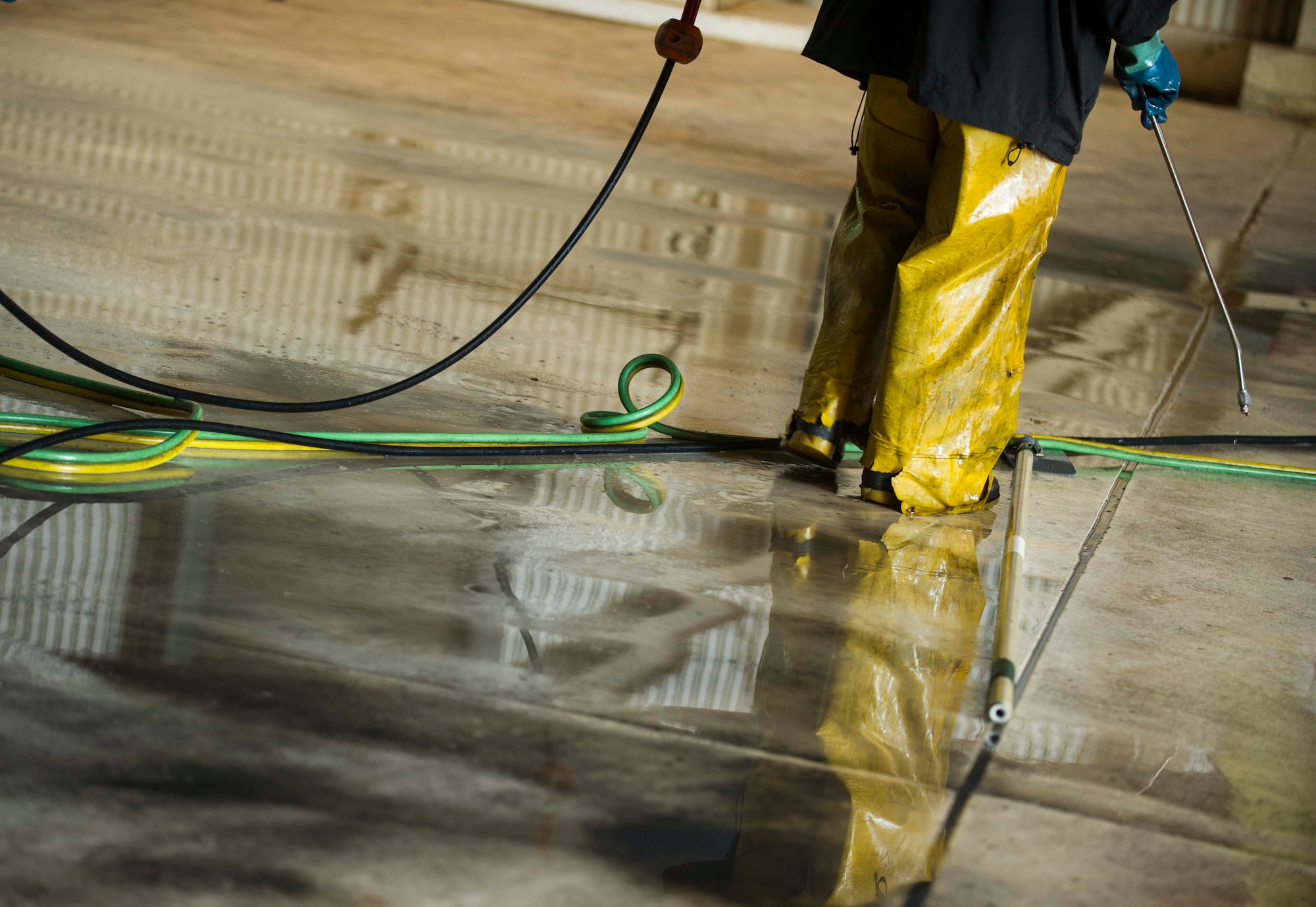 An Airman from the 5th Aircraft Maintenance Squadron prepares to spray a B-52H Stratofortress during a BUFF wash at Minot Air Force Base, N.D., July 25, 2016. Specialized cleaning solutions are used to remove grease and contaminants the aircraft has accumulated during flight and maintenance. (U.S. Air Force photo/Senior Airman Apryl Hall)