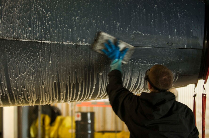 An Airman from the 5th Aircraft Maintenance Squadron scrubs a B-52H Stratofortress during a BUFF wash at Minot Air Force Base, N.D., July 25, 2016. Each aircraft is required to be washed every 120 days or after 450 flying hours. (U.S. Air Force photo/Senior Airman Apryl Hall)