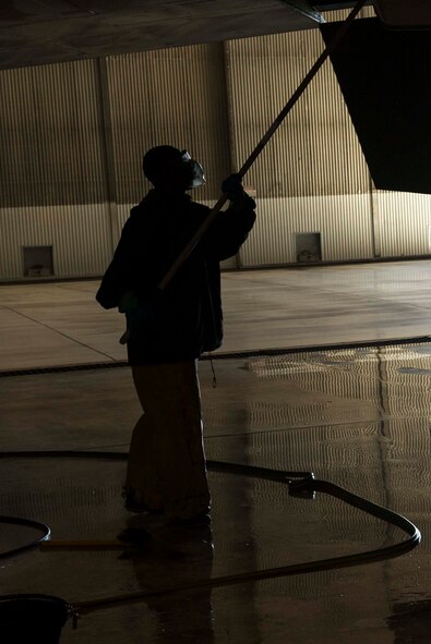 An Airman from the 5th Aircraft Maintenance Squadron washes the wing of a B-52H Stratofortress during a BUFF wash at Minot Air Force Base, N.D., July 25, 2016. Each aircraft receives a wash at least every 120 days. (U.S. Air Force photo/Senior Airman Apryl Hall)