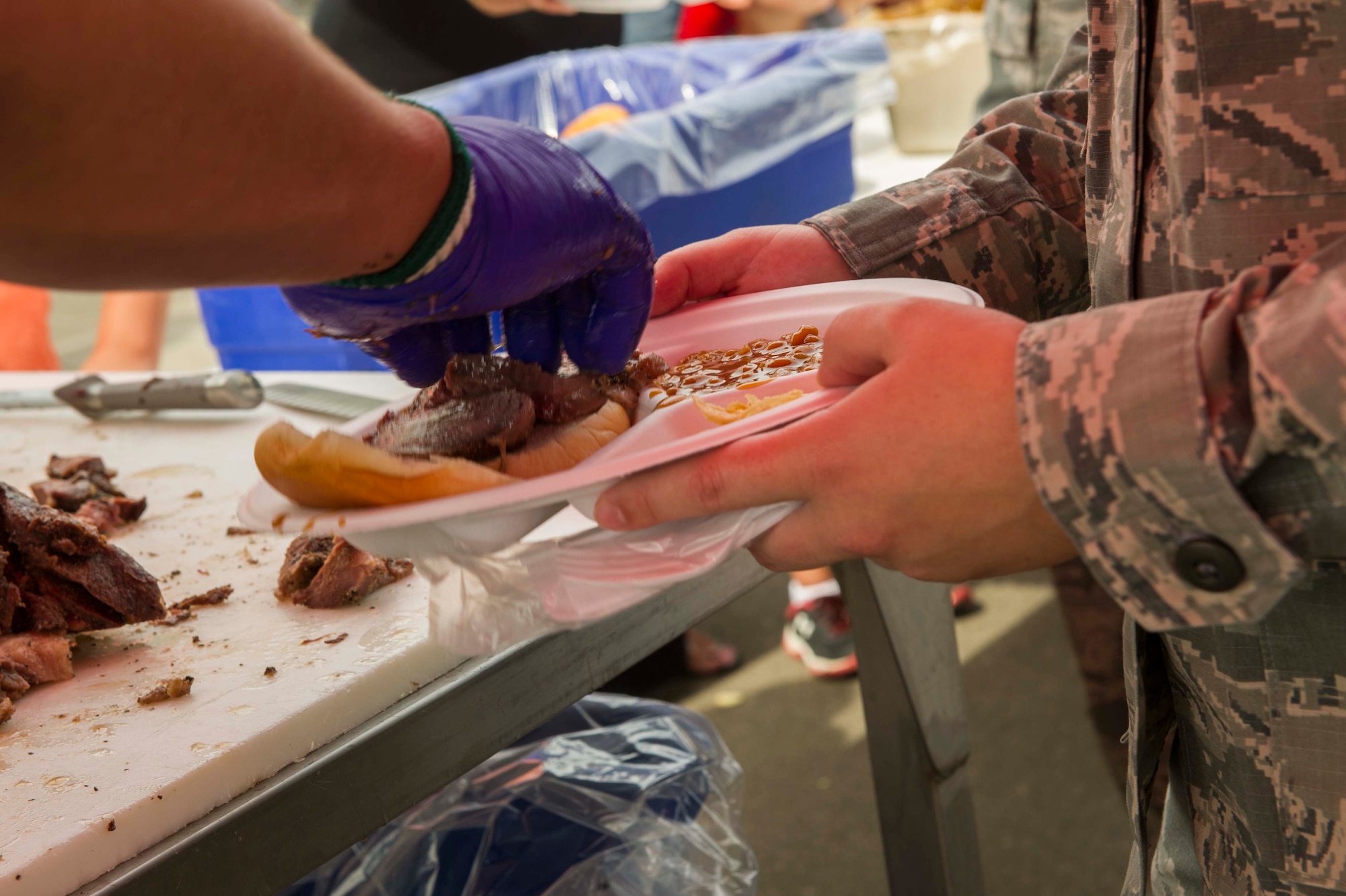 An Airman is served lunch at the beef picnic during Military Appreciation Day at the North Dakota State Fair in Minot, N.D., July 26, 2016. Each year, several agricultural agencies across the state sponsor the free meal for service members and their families. (U.S. Air Force photo/Senior Airman Apryl Hall)