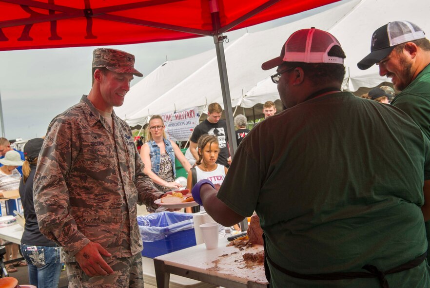 Col. Matthew Brooks, 5th Bomb Wing commander, gets lunch at the beef picnic during Military Appreciation Day at the North Dakota State Fair in Minot, N.D., July 26, 2016. The day also included discounted entry and tickets, in addition to free rides for service members and their families. (U.S. Air Force photo/Senior Airman Apryl Hall)