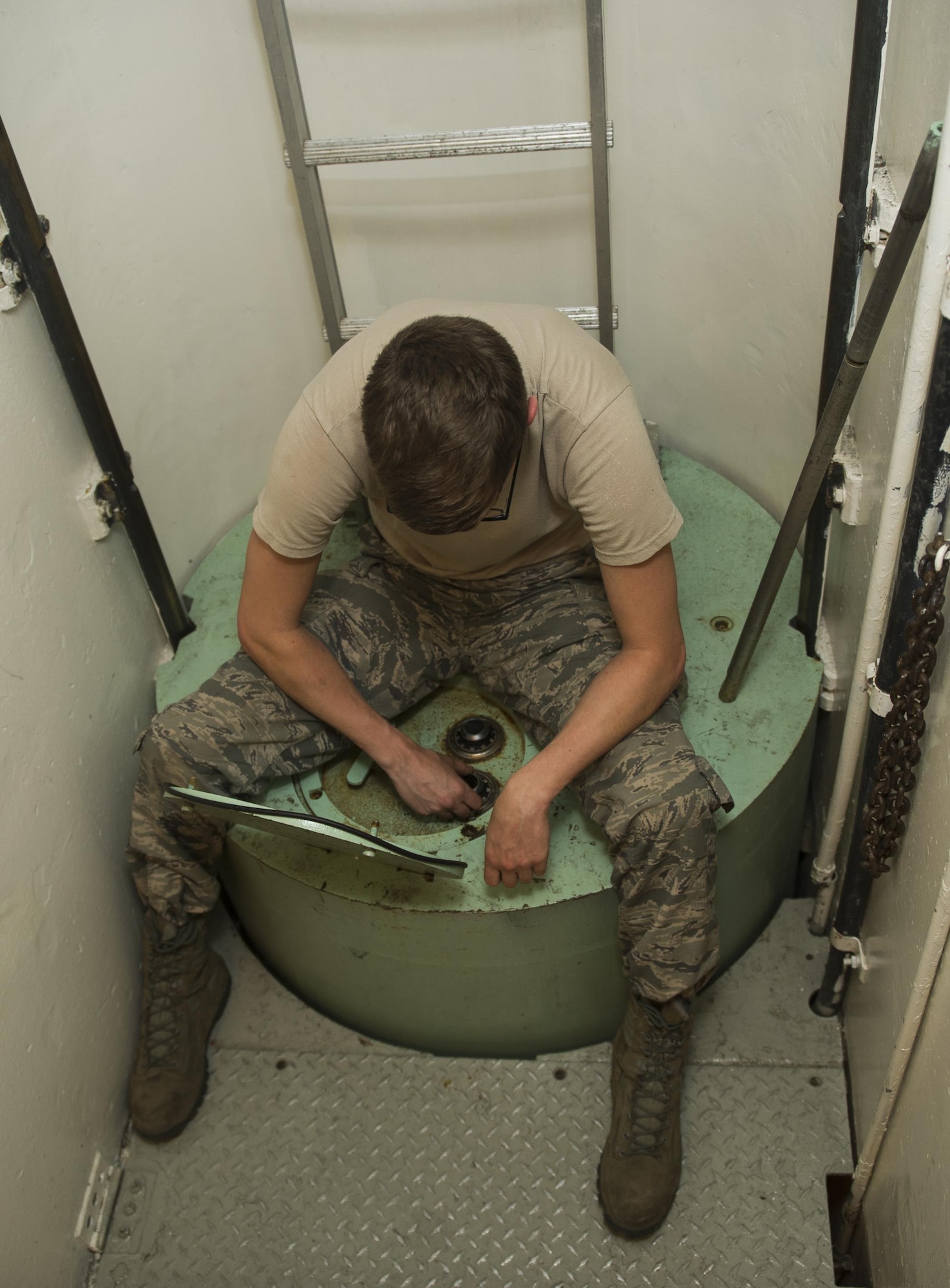 Senior Airman Sean Carnett, 91st Missile Maintenance Squadron electromechanical technician, adjusts the dial on the secondary door combination lock during training at Minot Air Force Base, N.D., July 27, 2016. Making sure the technicians understand how the locks operate and effect other components in the secondary door ensures the security works smoothly to keep the launch facilities secure. (U.S. Air Force photo/Airman 1st Class Christian Sullivan)