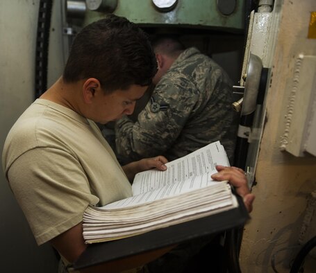 Senior Airman Andrew Zamlen, 91st Missile Maintenance Squadron electromechanical technician, reads technical orders during training at Minot Air Force Base, N.D., July 27, 2016. The EMT flight train often on the secondary door combination locks to maintain security of the launch facilities. (U.S. Air Force photo/Airman 1st Class Christian Sullivan)
