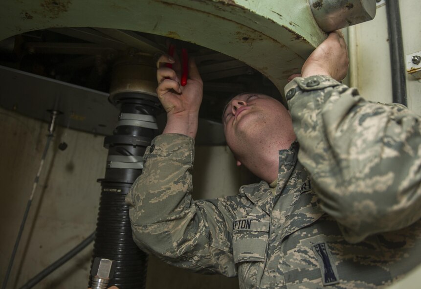 Airman 1st Class Joseph McHatton, 91st Missile Maintenance Squadron electromechanical technician, works on the secondary door combination lock at Minot Air Force Base, N.D., July 27, 2016. Making sure the technicians understand how the locks operate and effect other components in the secondary door ensures the security works smoothly to keep the launch facilities secure. (U.S. Air Force photo/Airman 1st Class Christian Sullivan)