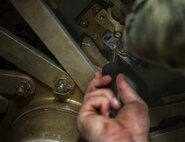 Airman 1st Class Joseph Mchatton, 91st Missile Maintenance Squadron electromechanical technician, tightens a screw on the secondary door combination lock at Minot Air Force Base, N.D., July 27, 2016. EMTs makes sure the locks are always in working order so launch facilities are safe and secure. (U.S. Air Force photo/Airman 1st Class Christian Sullivan)