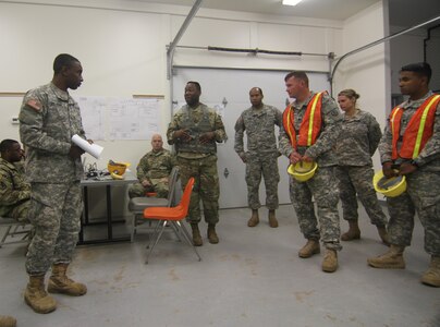 Supplying the warfighter with strategic deployment capabilities.
1st Lt. Quentin Fillmore, battle captain, and Staff Sgt.  Orion Barnes, automated information for movement systems non-commissioned officer in charge of the 352d Expeditionary Terminal Operations Element based in Sanford, Florida, brief the unit during Army Reserve exercise TRANS WARRIOR 2016. The exercise provides Mission Essential Task List focused training and  addresses fundamental Soldier skills. The TRANSWARRIOR exercise lasted from July 9 to July 23, 2016. (U.S. Army Reserve photo by 1st Sgt. Timothy Lawn, 205th Press Camp Headquarters)