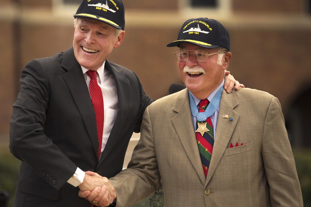 Navy Secretary Ray Mabus shakes hands with retired Marine Corps Col. Harvey C. Barnum Jr., a Medal of Honor recipient, during a naming ceremony for the USS Harvey C. Barnum Jr. at Marine Barracks Washington, D.C., July 28, 2016. Marine Corps photo by Lance Cpl. Dana Beesley