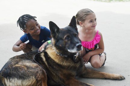 Max, assigned to Arlington Heights Police Department K9 unit, pauses for a photo with children during the 85th Support Command's Family Day event on July 10, 2016 in Arlington Heights. 
 (Photo by Sgt. First Class Anthony L. Taylor)