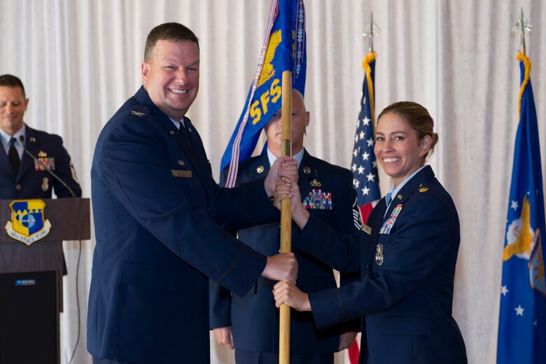 Col. Matthew Wallace, 45th Mission Support Group commander, presents Maj. Megan Hall, 45th Security Forces Squadron guidon during a change of command ceremony July 29, 2016, at Patrick Air Force Base, Fla. Changes of command are a military tradition representing the transfer of responsibilities from the presiding official to the upcoming official. (U.S. Air Force photo/Matthew Jurgens)