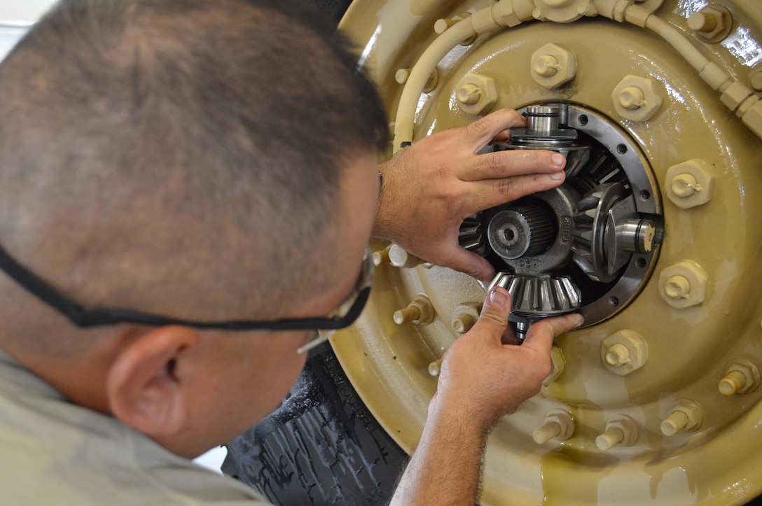 Army Reserve Spc. Ricardo A. Martinez, of 79th Quartermaster Company, from Houston, Tx., replaces a wheel gear assembly during Platinum Wrench Annual Exercise at Ft. McCoy, Wis., on July 26, 2016. The hands-on exercise gives Soldiers training in maintenance procedures. (U.S. Army photo by Spc. Joseph Driver/Released)