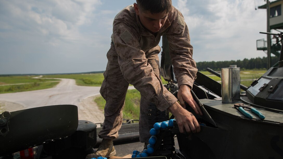 An amphibious assault vehicle crewman with Alpha Company, 2nd Assault Amphibian Battalion, loads simulation rounds into a mounted MK-19 40mm grenade launcher during a live-fire gunnery range at Marine Corps Base Camp Lejeune, North Carolina, July 27, 2016. Marines with the battalion spent the day refining their marksmanship skill as individuals and their ability to work as a crew.