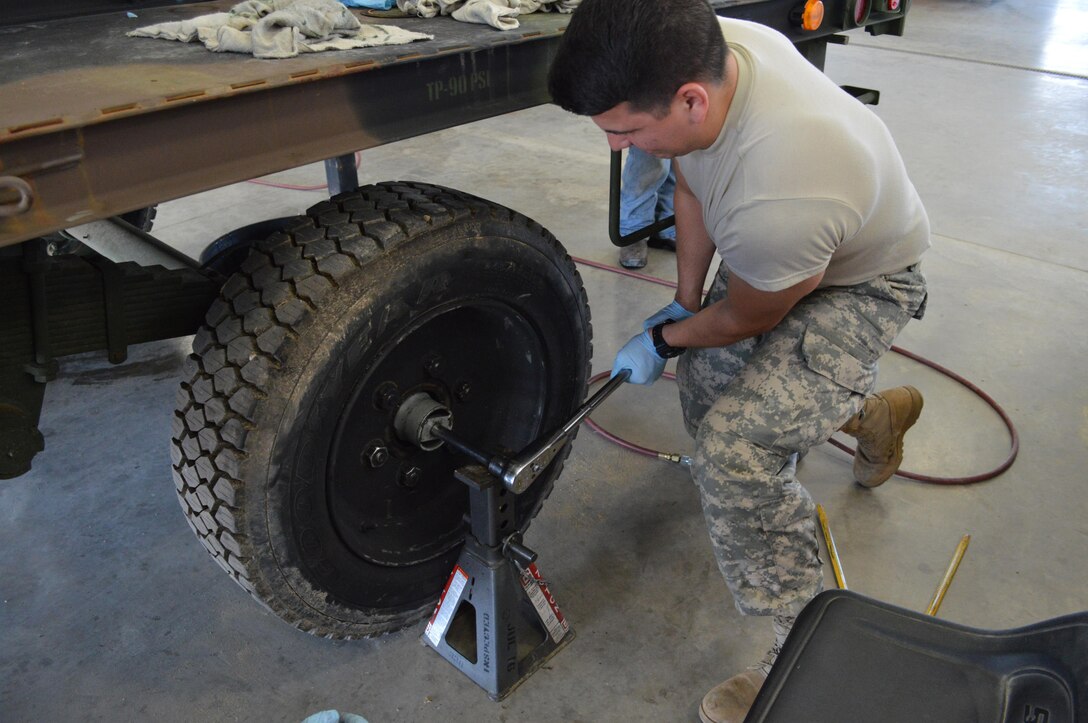 Army Reserve Spc. Martin A. Silva Bel, of 818th Support Maintenance Company, Fort
George G. Meade, Md., sets the outer retainer torque on a wheel bearing assembly on a trailer during Platinum
Wrench Annual Exercise at Ft. McCoy, Wis., on July 27, 2016. The hands-on exercise
gives Soldiers training in maintenance procedures. (U.S. Army photo by Spc. Thomas
Watters/Released)