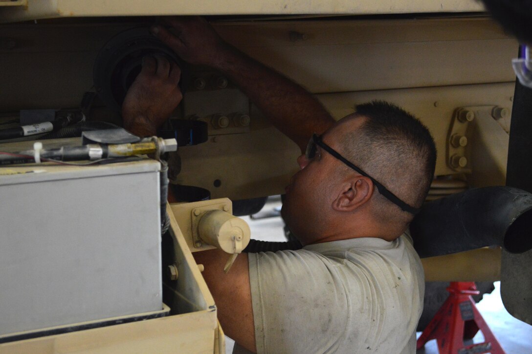 Army Reserve Spc. Ricardo A. Martinez, of 79th Quartermaster Company, from
Houston, Tx., performs vehicle maintenance on a Light Medium Tactical Vehicle (LMTV) during Platinum Wrench Annual
Exercise at Ft. McCoy, Wis., on July 27, 2016. The hands-on exercise gives Soldiers
training in maintenance procedures. (U.S. Army photo by Spc. Thomas
Watters/Released)