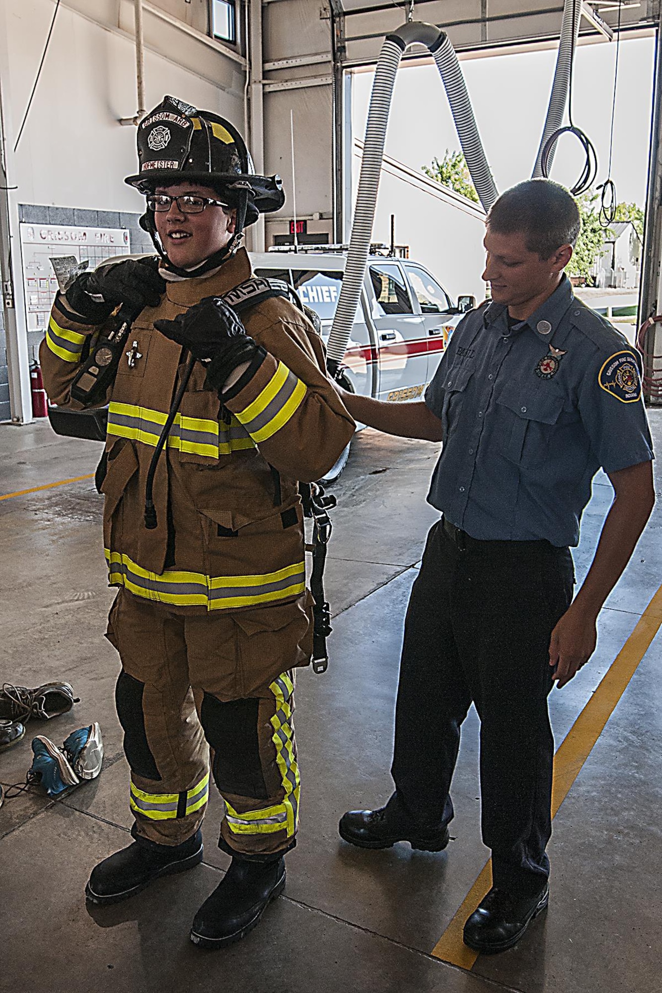 Cory Paull, A firefighter with the 434th Civil Engineer Squadron, helps Stefan Spencer, a Boy Scout, tries on firefighting gear July 27, 2016 at Grissom Air Reserve Base, Ind. While visiting the Fire Department as part of a base tour several of the scouts were encouraged to try on the firefighting gear. (U.S. Air Force photo/Senior Airman Dakota Bergl)