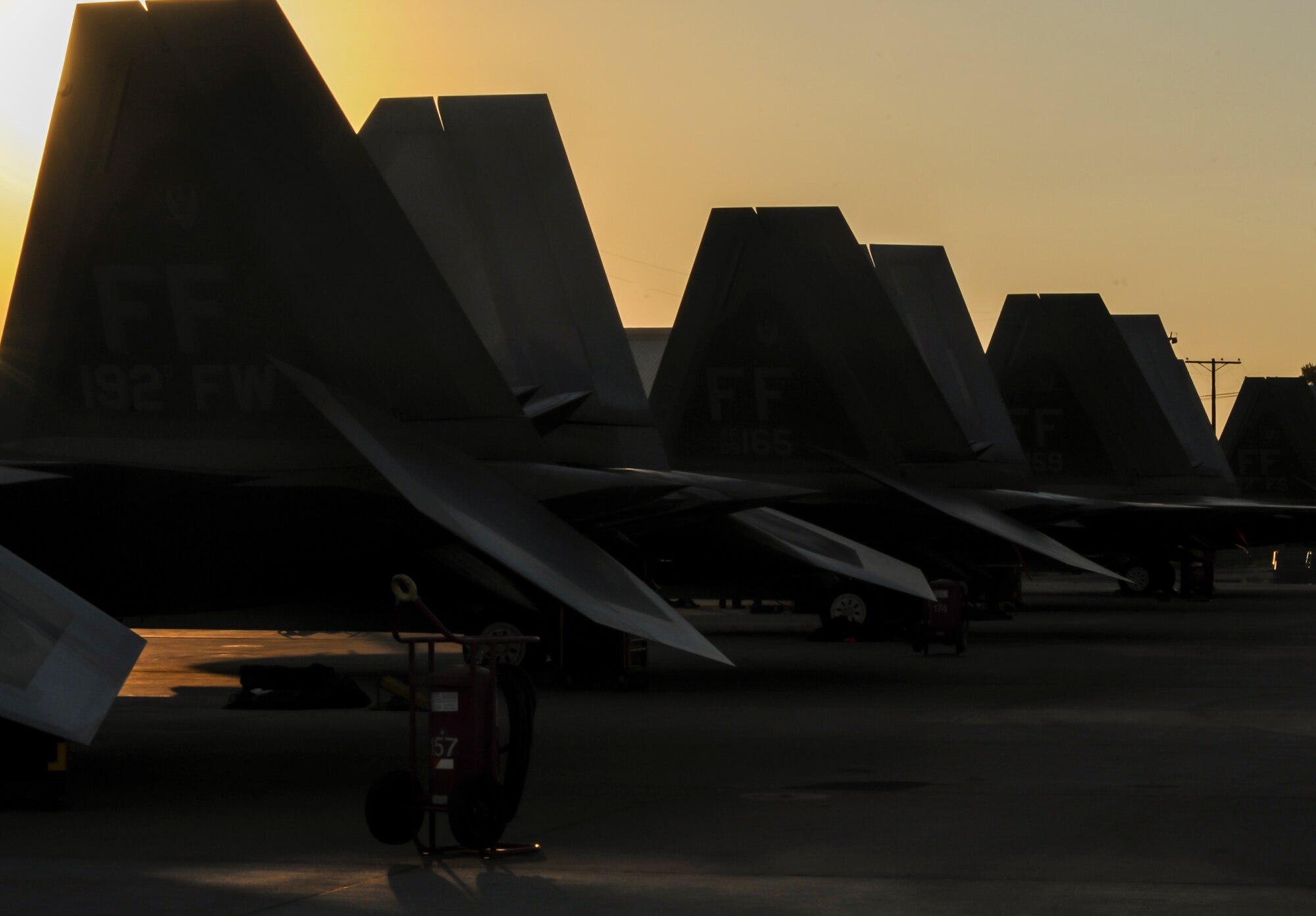 F-22A Raptors, assigned to the 27th Fighter Squadron, Joint Base Langley-Eustis, Va., sit on the flightline before take-off during Red Flag 16-3 at Nellis Air Force Base, July 25, 2016. Red Flag provides a series of intense air-to-air scenarios for aircrew and ground personnel which will increase their combat readiness and effectiveness for future real world missions. (U.S. Air Force photo by Airman 1st Class Kevin Tanenbaum/Released)