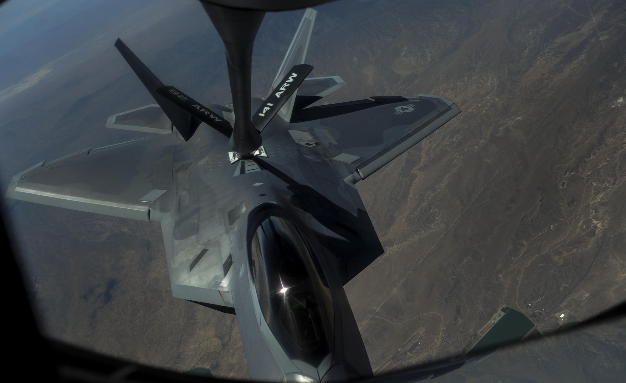 An F-22A Raptor, assigned to the 27th Fighter Squadron, Joint Base Langley-Eustis, Va., is refueled in-air by a KC-135 Stratotanker during Red Flag 16-3 over the Nevada Test and Training Range, Nev., July 27, 2016. In addition to providing fuels for aircraft in mid-air, the KC-135 can carry up to 83,000 pounds of cargo. (U.S. Air Force photo by Airman 1st Class Kevin Tanenbaum/Released)